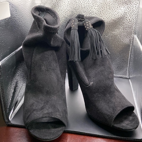 Black suede ankle heel boots with black and white tassel on back and open toe. - Picture 1 of 3